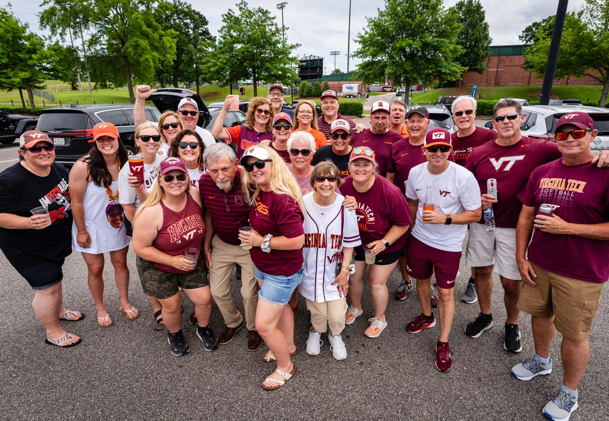 fans posing for a photo in parking lot