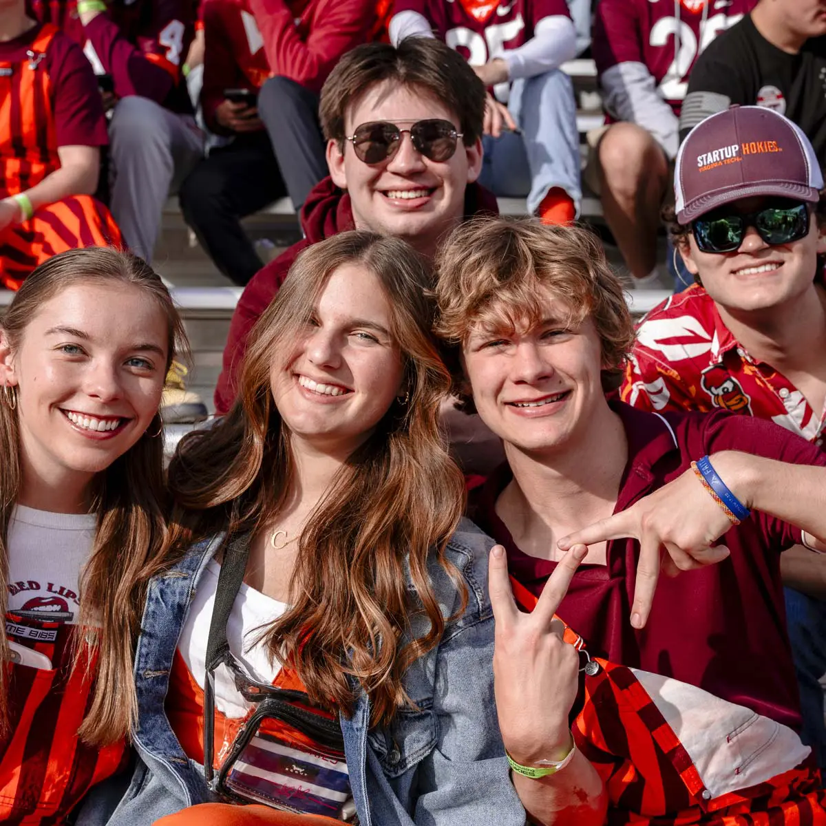 fans posing for photo in stands